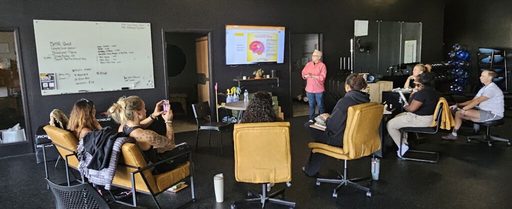 Bev speaking to the trainers at Sol Fitness about autism