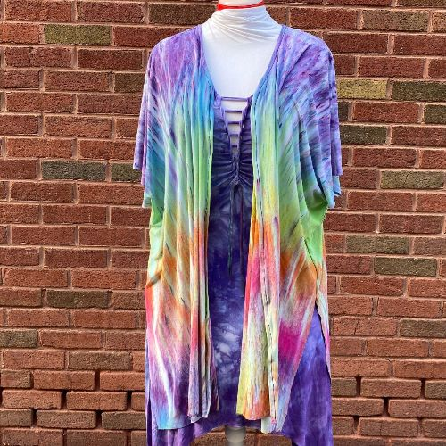 rainbow tie-dye shall on top of a purple tie-dye dress